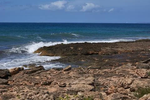 Rocks on the shore hit by the wave Stock Photos