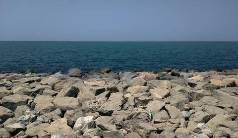 Rocks on the shore of the ocean. Stock Photos