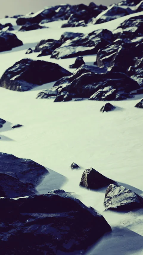 Rocks on shore with waves washing over in coastal scene Stock Footage 334248787