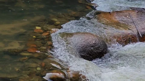 The rocks for a small water fall and the water turns white. Stock Footage 305366364