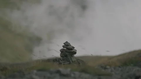 Rocks stacked on the mountain with clouds in the background Stock Footage 297792444