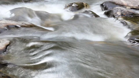 Rocks in stream with smooth flowing water Stock Footage 65264543