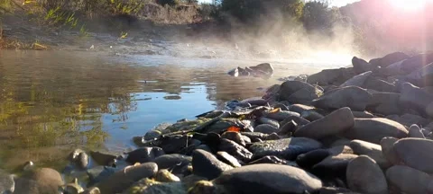 Rocks in a stream with smooth fluid vapor water Stock Footage 164731677