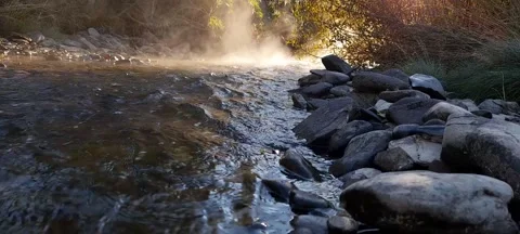 Rocks in a stream with smooth fluid vapor water Stock Footage 164731679