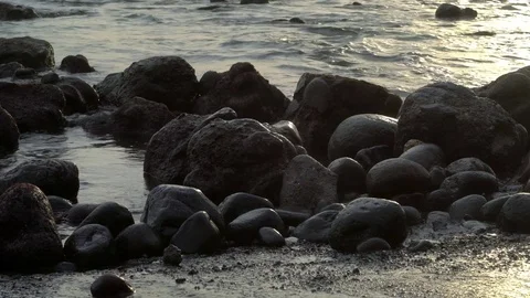 Rocks in a tide pool during sunset Stock Footage 74290402