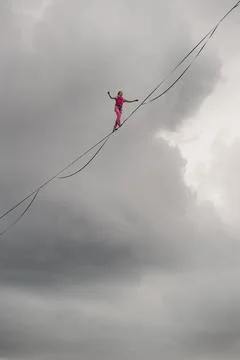 Rocks of a Triangular lake, Russia - August 2, 2021: Highliner girl on the ba 스톡 사진