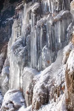 Rocks under ice layers and phantasmagoric ice shapes, frozen leaves, Czech. Stock Photos