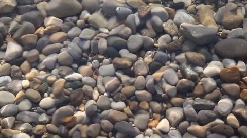 Rocks under the waves of some rippling clear fresh water Video stock 89821507