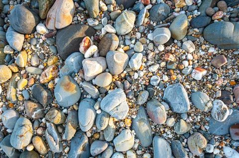 Rocks of various sizes on the sandy beach in front of Koh Lanta Lighthouse Stock Photos