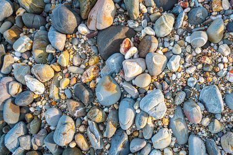 Rocks of various sizes on the sandy beach in front of Koh Lanta Lighthouse Stock Photos
