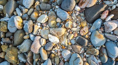 Rocks of various sizes on the sandy beach in front of Koh Lanta Lighthouse Stock Photos