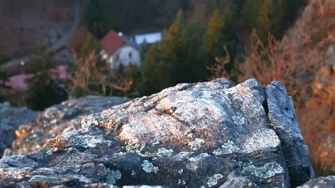 Rocks with view of deep valley and house. 4K resolution trucking shot. Stock-Footage 100319222