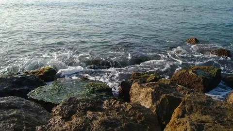 Rocks where the waves break on the beach of Port Ginesta in Barcelona. Stock Footage 116804625