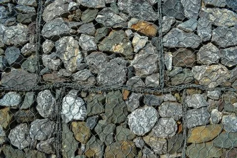 Rocks in wire mesh Stock Photos