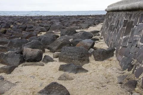 Rockwall at a beach Stock Photos