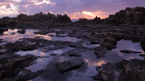Rocky Alien Landscape with Rock Pools Reflecting a Beautiful Sunrise Stock Footage 35169783