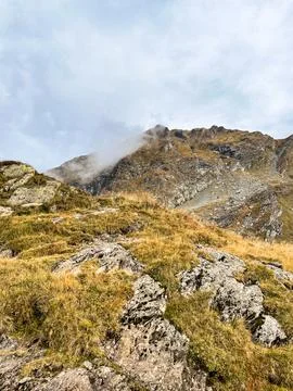 Rocky alpine ridge with low clouds, Fagaras Mountains, Romania Stock Photos
