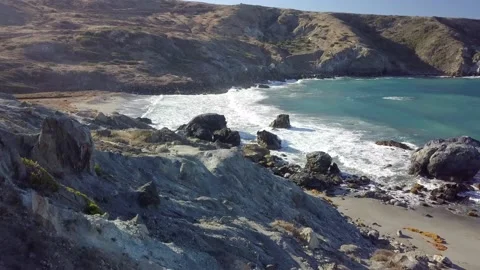 Rocky and Rugged Beach with Waves Crashing Stockbeeldmateriaal 221374959