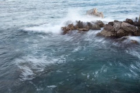 Rocky and the waves Stock Photos