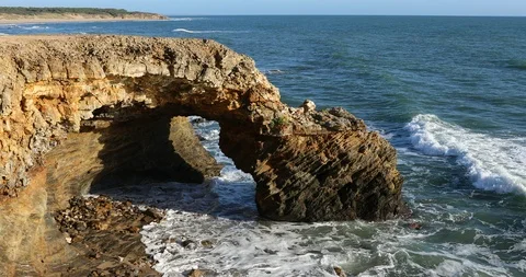 Rocky arch on the coast Stock Footage 121151902