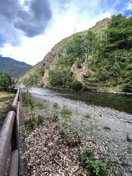 Rocky area on the shore of a river between mountains. Photos