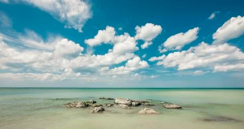 Rocky Beach and the clouds Stock Photos