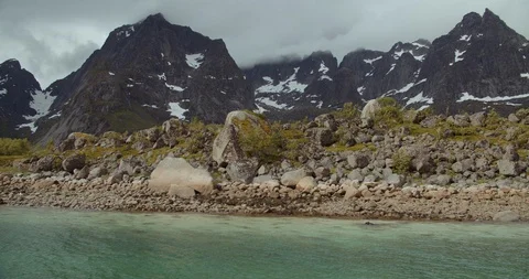 Rocky beach and mountains in the background in Lofoten- Norway Stock Footage 129737026