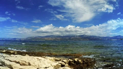 Rocky beach and small boat on the horizon at sunny day on Island of Brac Stock Footage 167580672
