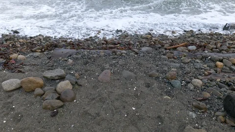 Rocky beach with big waves and slow tilt up in slow motion Stock Footage 121697141