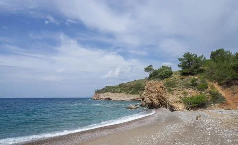 Rocky Beach with Cliff and Dramatic Cloudy Sky 스톡 사진