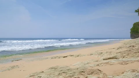 Rocky beach during low tide in sunny afternoon with big ocean waves Stock Footage 114991337