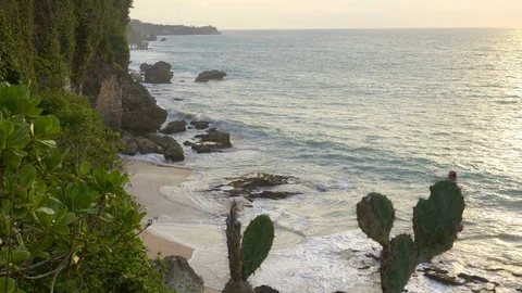 Rocky beach during sunset with big high tide waves Stock Footage 114989110