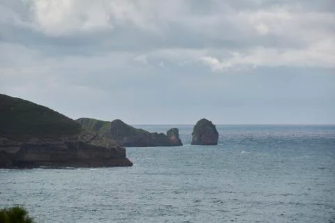 Rocky beach with gray clouds after the storm. Stock Photos