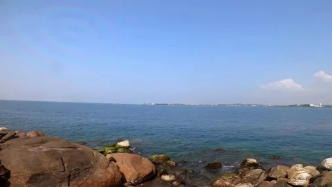 Rocky beach pan shot with full aerial coverage with clear blue sky Stock Footage 239124148