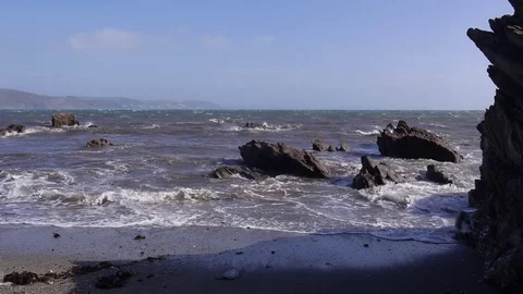 Rocky beach, small powerful waves at high tide Stock Footage 81234339