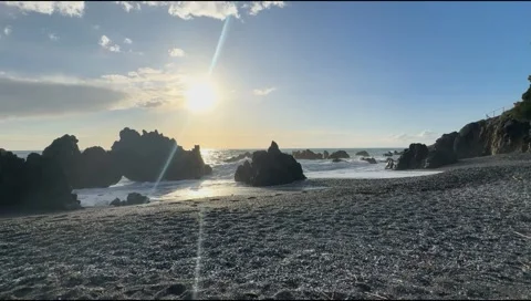 Rocky Beach at Sunset with Ocean Waves Stock Footage 303407675