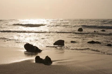 Rocky beach at sunset Stock Photos