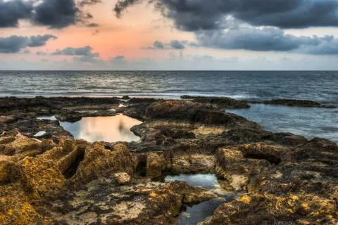Rocky beach at sunset Stock Photos