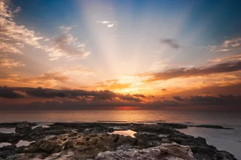Rocky beach at sunset Stock Photos