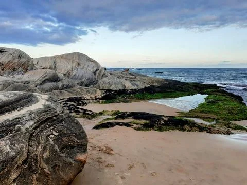 Rocky beach with tide pool Stock Photos
