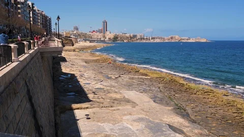 The rocky beach in Tower road in Sliema, Malta Stock Footage 112005053