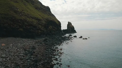 Rocky beach with towering cliffs overlooking the ocean - Drone 4k 動画素材 113746563