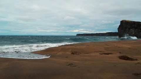A rocky beach with volcanic basalt formations in West Iceland Stock Footage 121564544