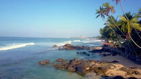 Rocky beach washed by waves of ocean in tropical area 스톡 동영상 248052229
