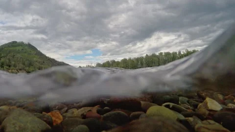 The rocky bottom of a mountain river with a fast current and clear water. Stock-Footage 303359926