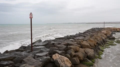 Rocky Breakwater with Waves on a Cloudy Day 스톡 동영상 333618157