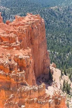 A rocky cliff with a forest in the background Stock Photos
