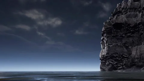Rocky cliff by the ocean under a clear sky with some clouds Stock Footage 339875151