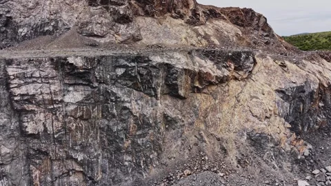 Rocky cliff in a quarry with rough textures and uneven surfaces Stock Footage 338275783