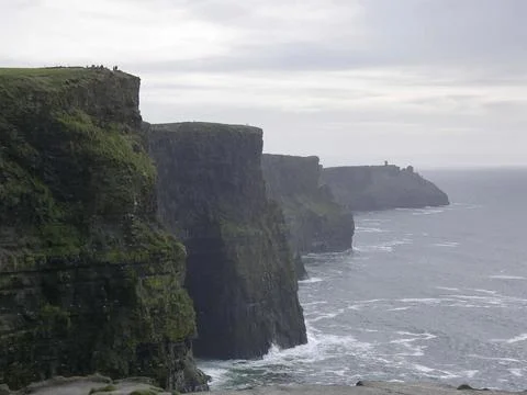 Rocky cliffs and big waves Stock Photos